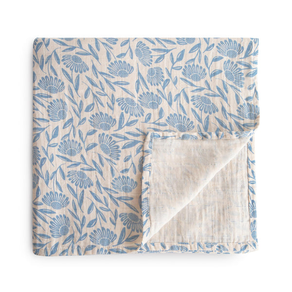 Mushie Muslin Swaddle Blanket blue flowers soft texture for newborn comfort.