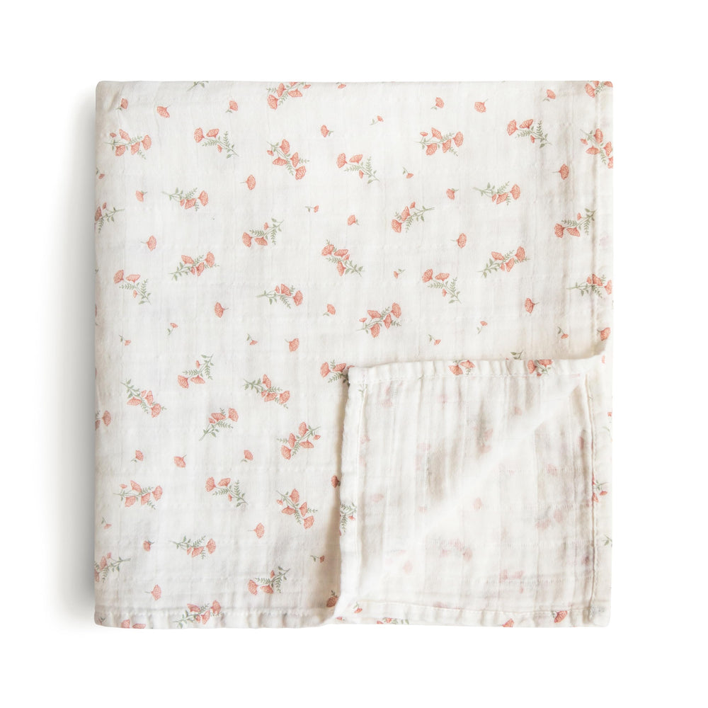Mushie muslin swaddle blanket in pink flowers offers breathable warmth and cozy coverage