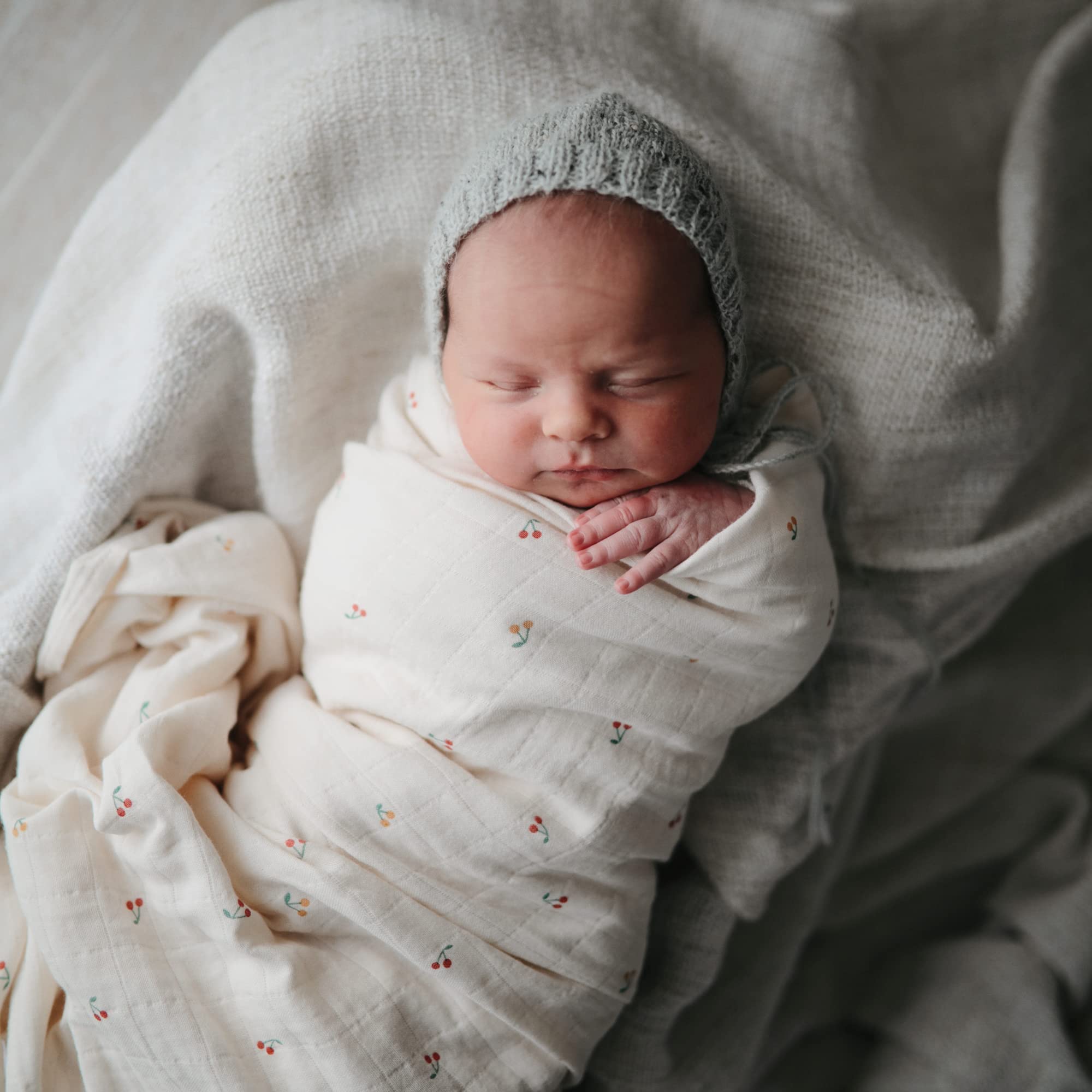 Mushie swaddle blanket shown for secure swaddling and calm baby moments