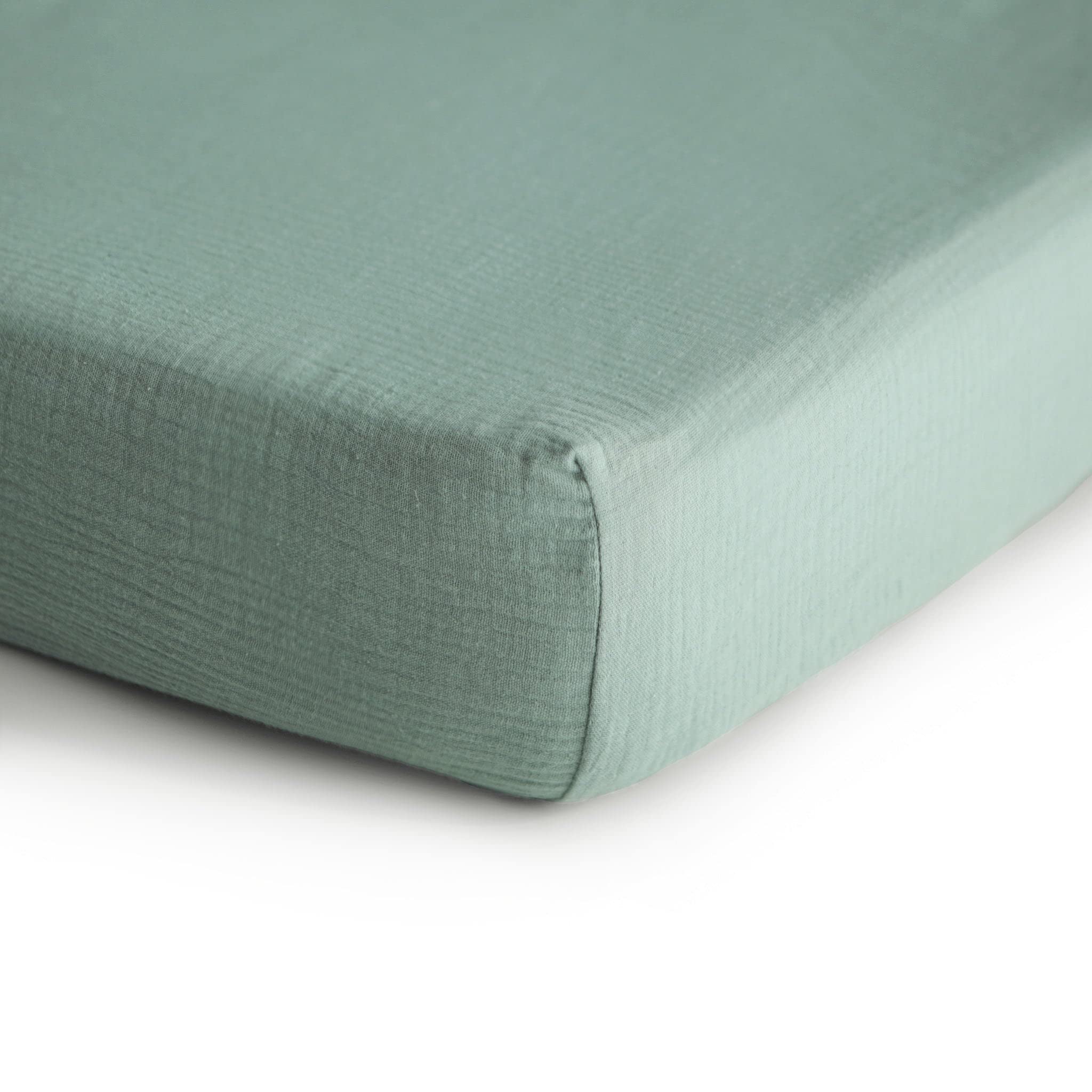 Mushie muslin texture closeup on mini crib sheet highlighting soft breathability
