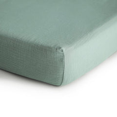 Mushie muslin texture closeup on mini crib sheet highlighting soft breathability