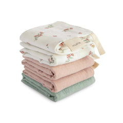 Mushie muslin washcloths with pink flowers design for gentle bath cleansing.