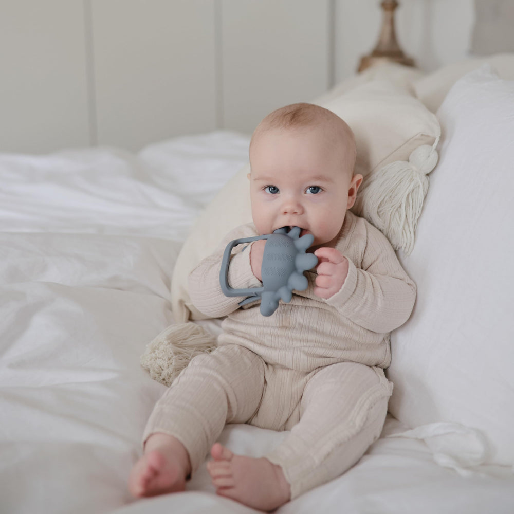 Mushie No-Drop Dino Teether silicone material is non-toxic and safe for mouthing.