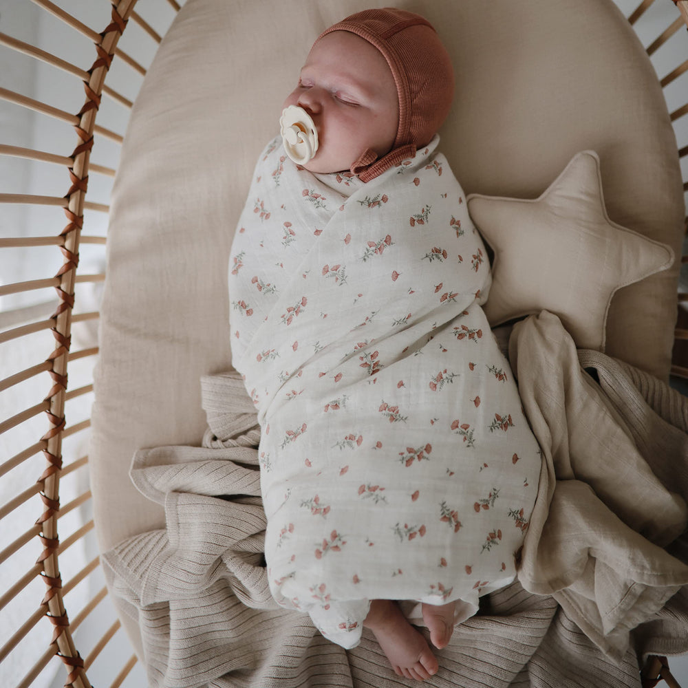 Mushie nursery snuggle swaddle demonstrates versatile use for swaddling and comforting your baby