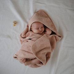 One-size Mushie towel laid flat with measurements 30.5 by 30.5 inches.