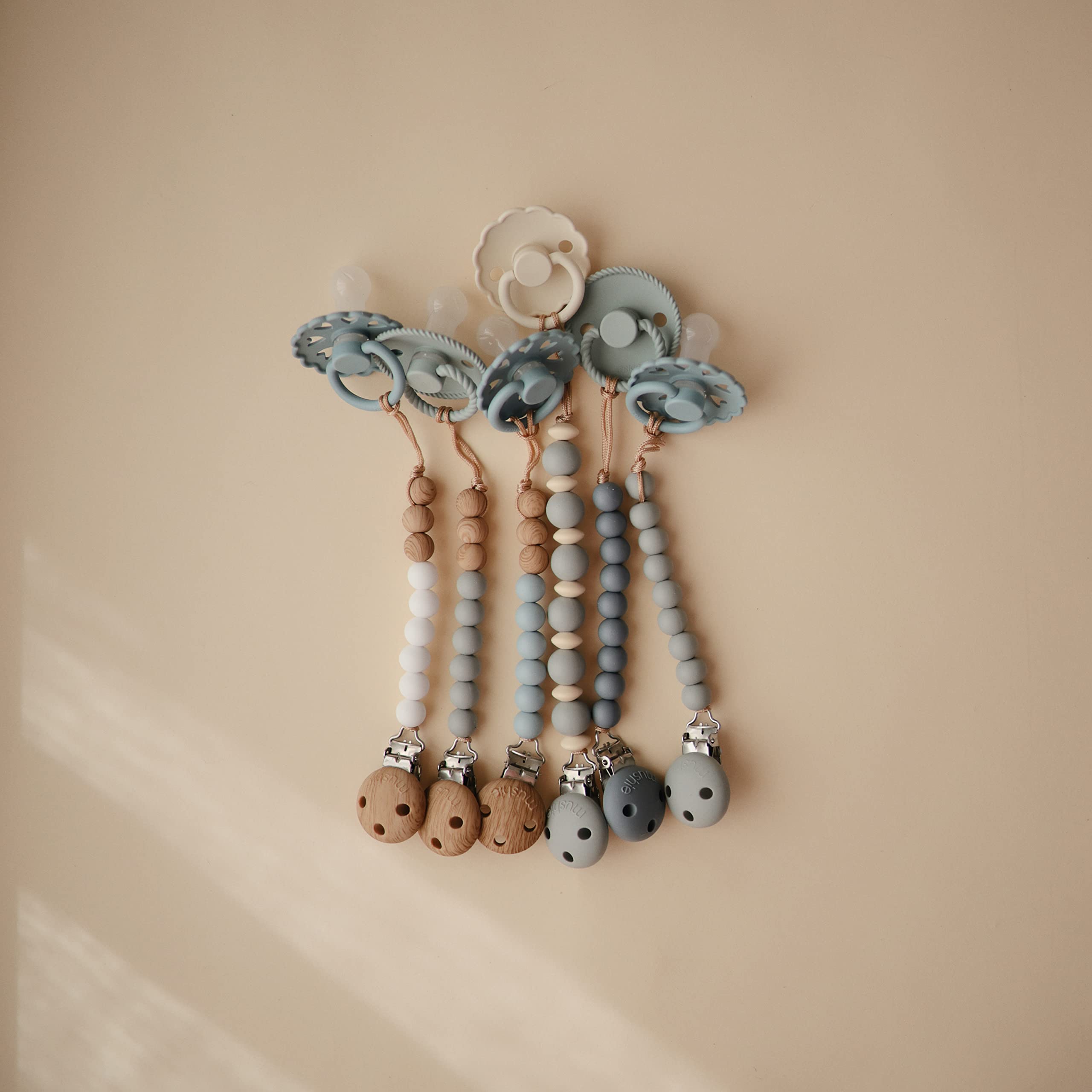 Mushie Eva pacifier clip supports on-the-go care for babies.