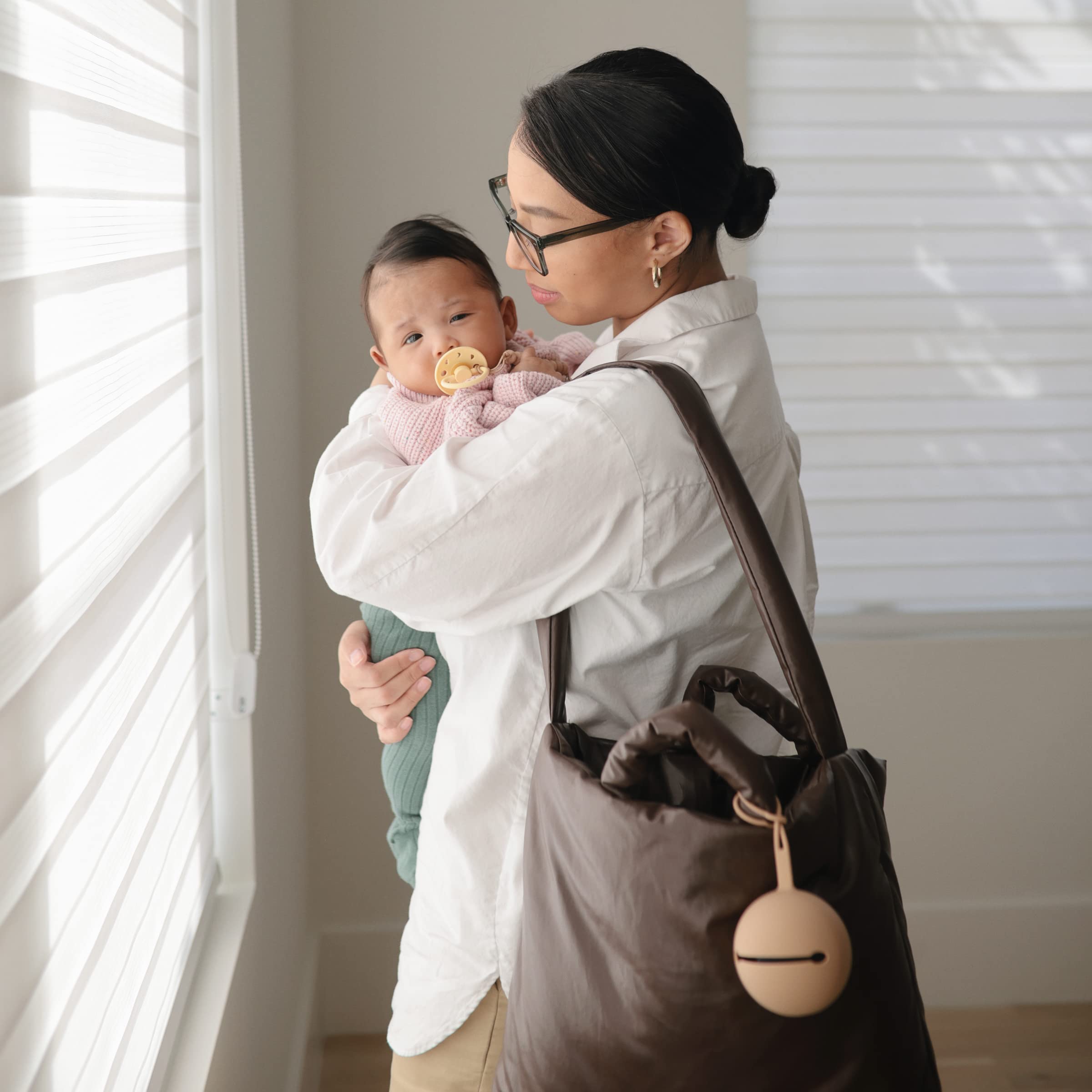 Mushie pacifier silicone case open with two pacifiers, keeps essentials organized.