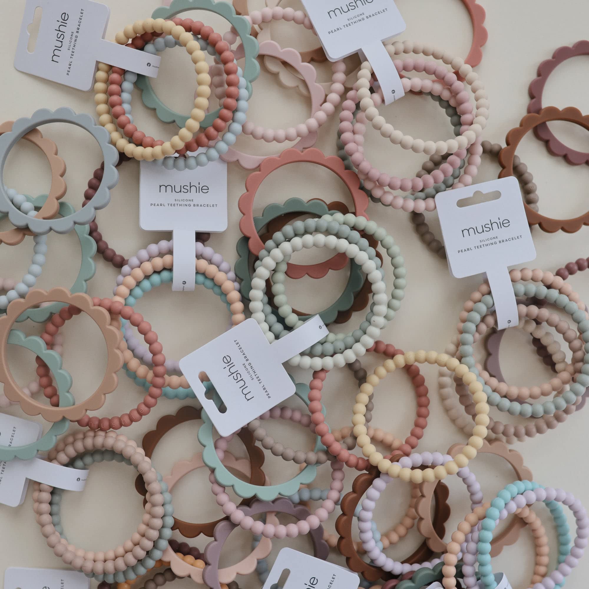 Mushie Pearl Teether Bracelet color-combo; lilac, cyan and peach for outfits