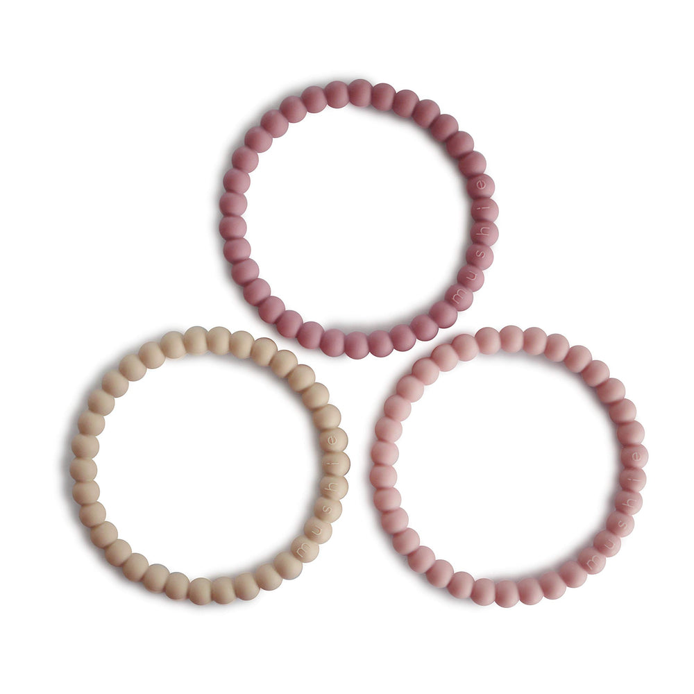 Mushie Pearl Teether Bracelet in Linen color, gentle silicone for soothing gums.