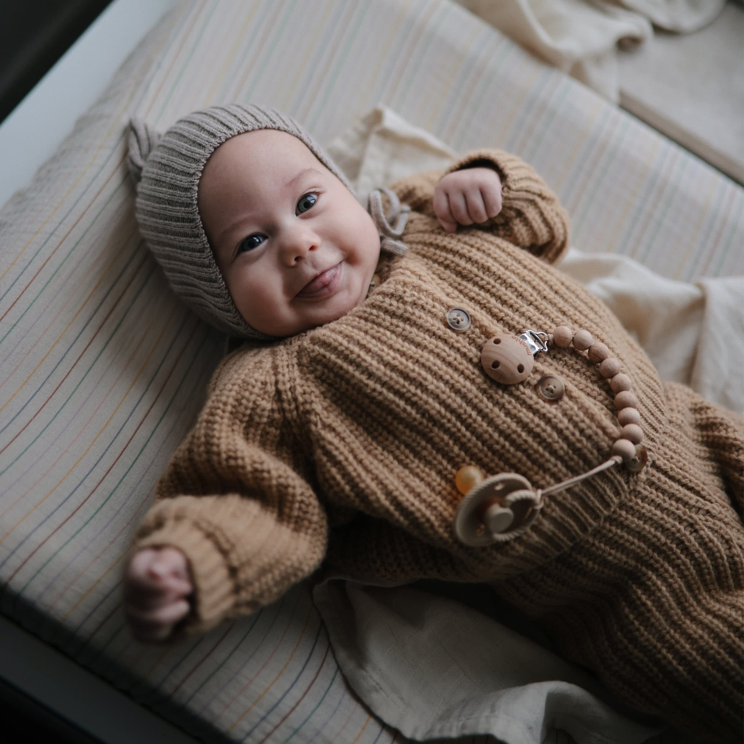 Mushie Roman Green muslin fabric shows breathable texture for baby comfort.
