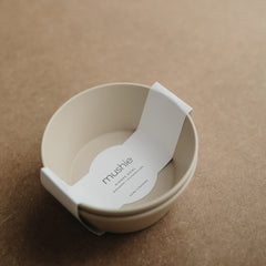 Mushie vanilla bowls on table during meal prep, compact and tidy.