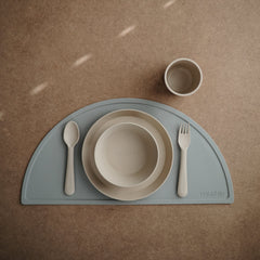 Mushie round dinnerware vanilla plate on a tray, perfect for home mealtime.