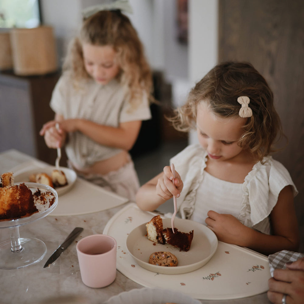 Mushie vanilla kids plate during travel, sturdy and stackable for on-the-go meals.