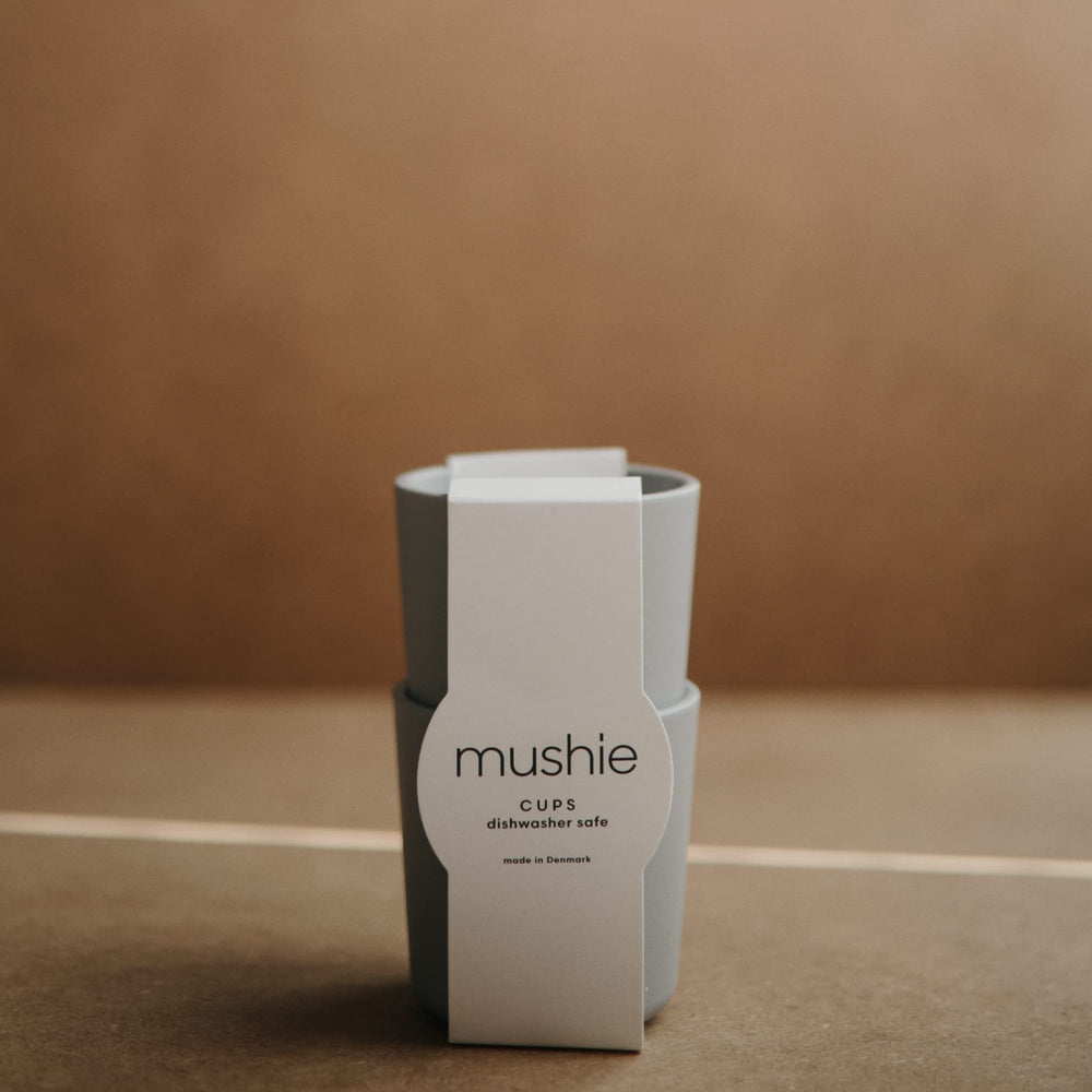 Mushie Sage cups stacked in a two-pack for compact storage.