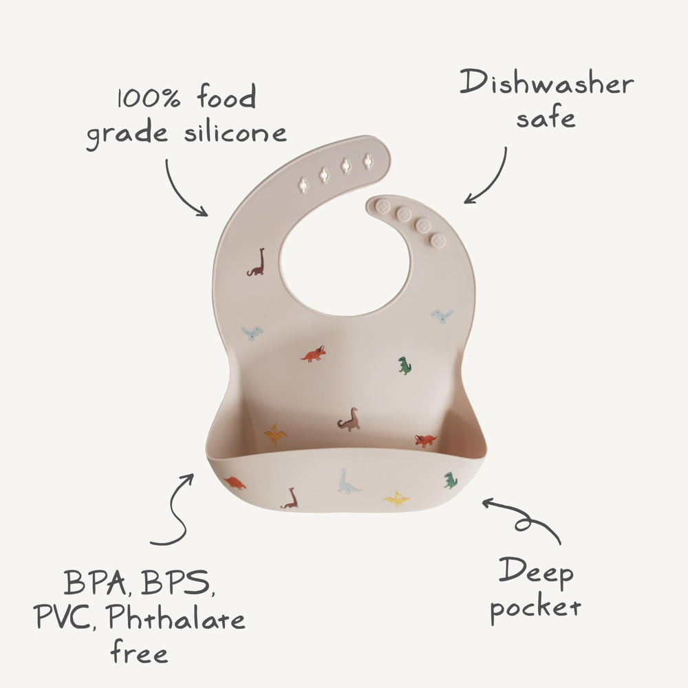 Mushie bib coordinates with placemats for a coordinated mealtime setup.