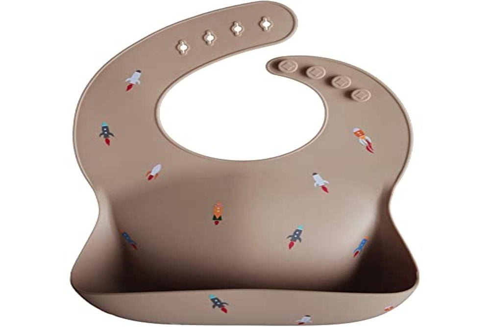 Mushie bib waterproof surface closeup highlighting easy wipe cleanup