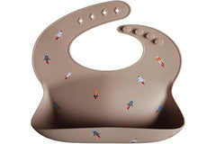 Mushie bib waterproof surface closeup highlighting easy wipe cleanup
