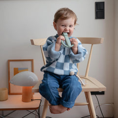 Mushie robot rattle teether provides cheerful sounds to engage baby.