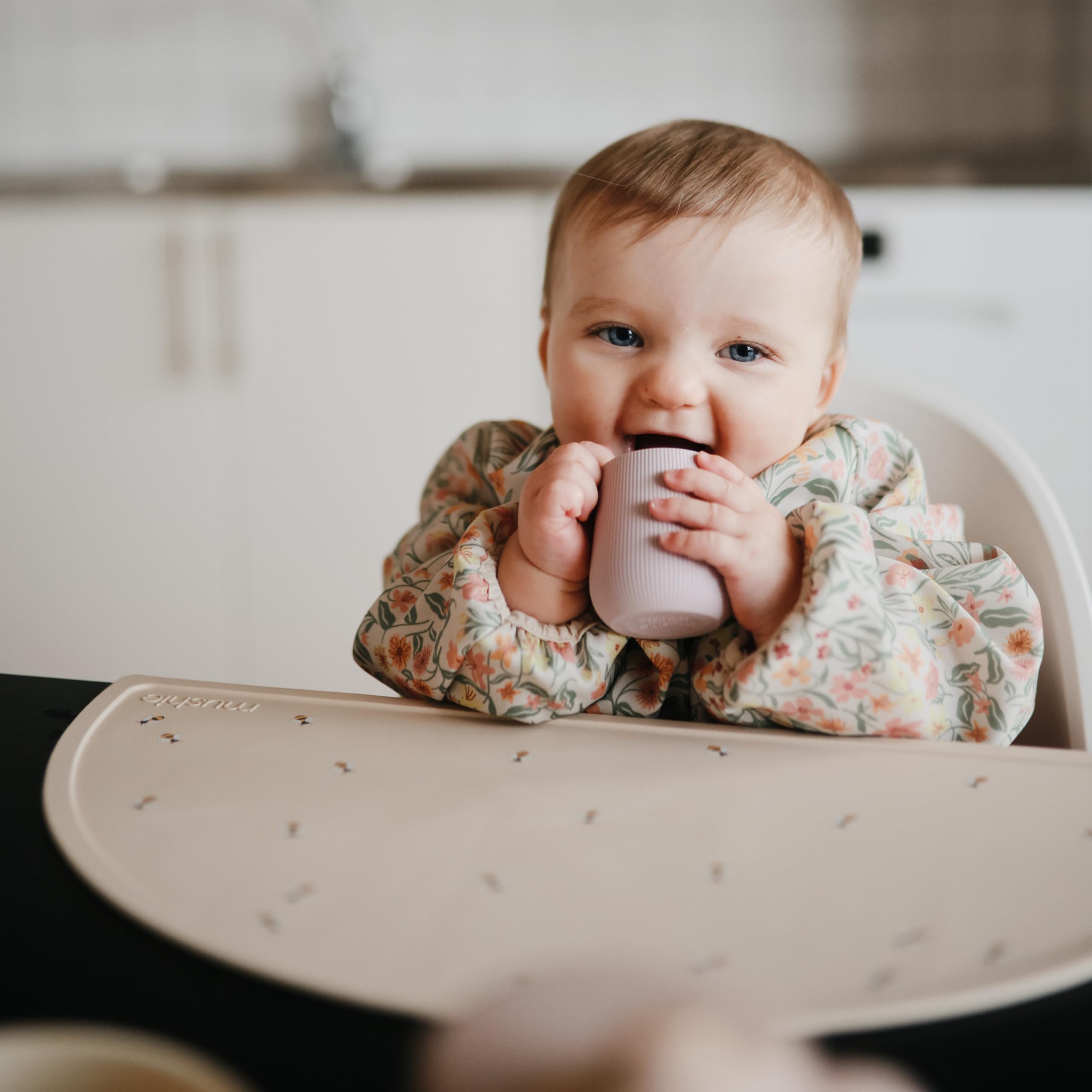 Mushie starter cup offers 2oz capacity for small, controlled sips.