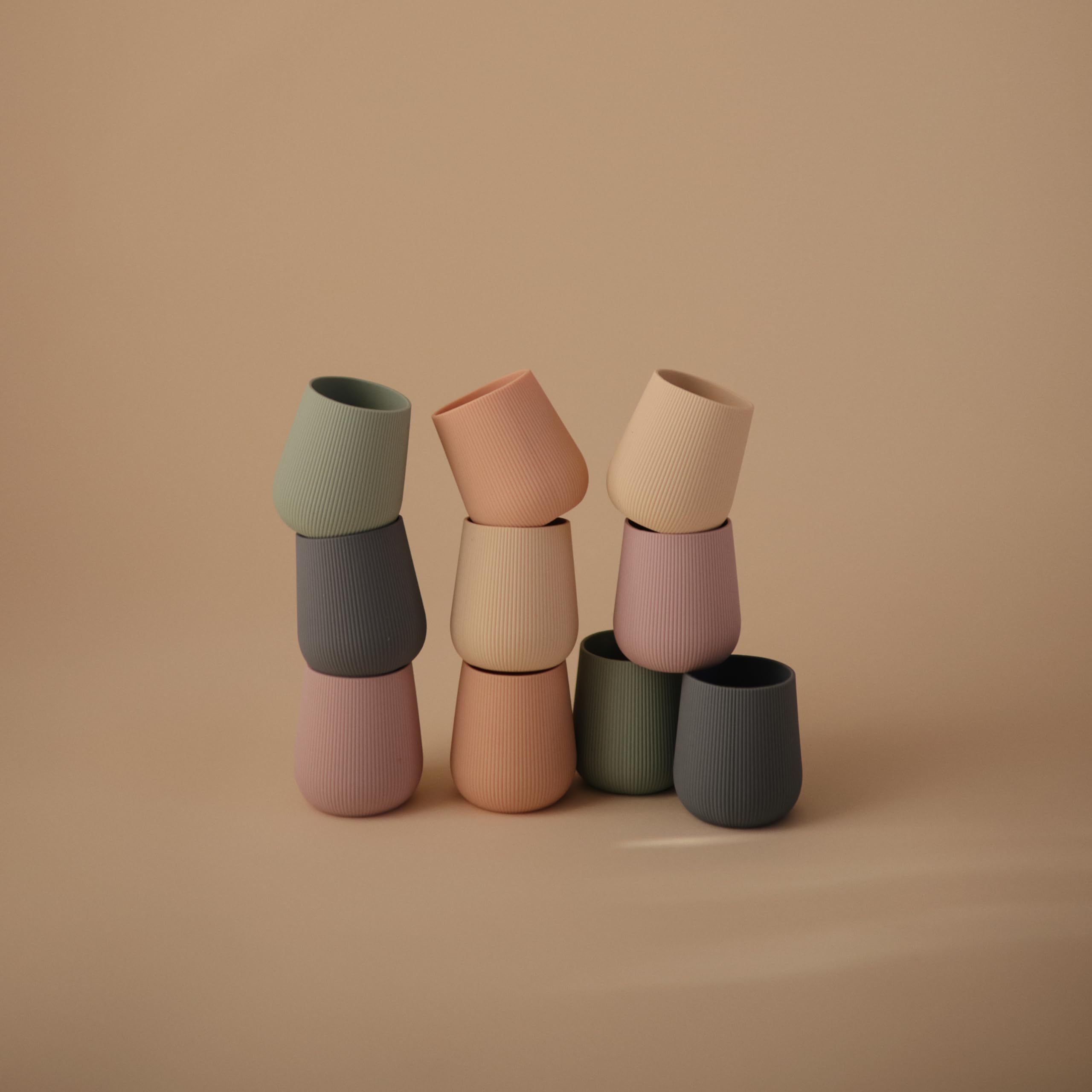 Mushie training cup supports early self-feeding and coordination.