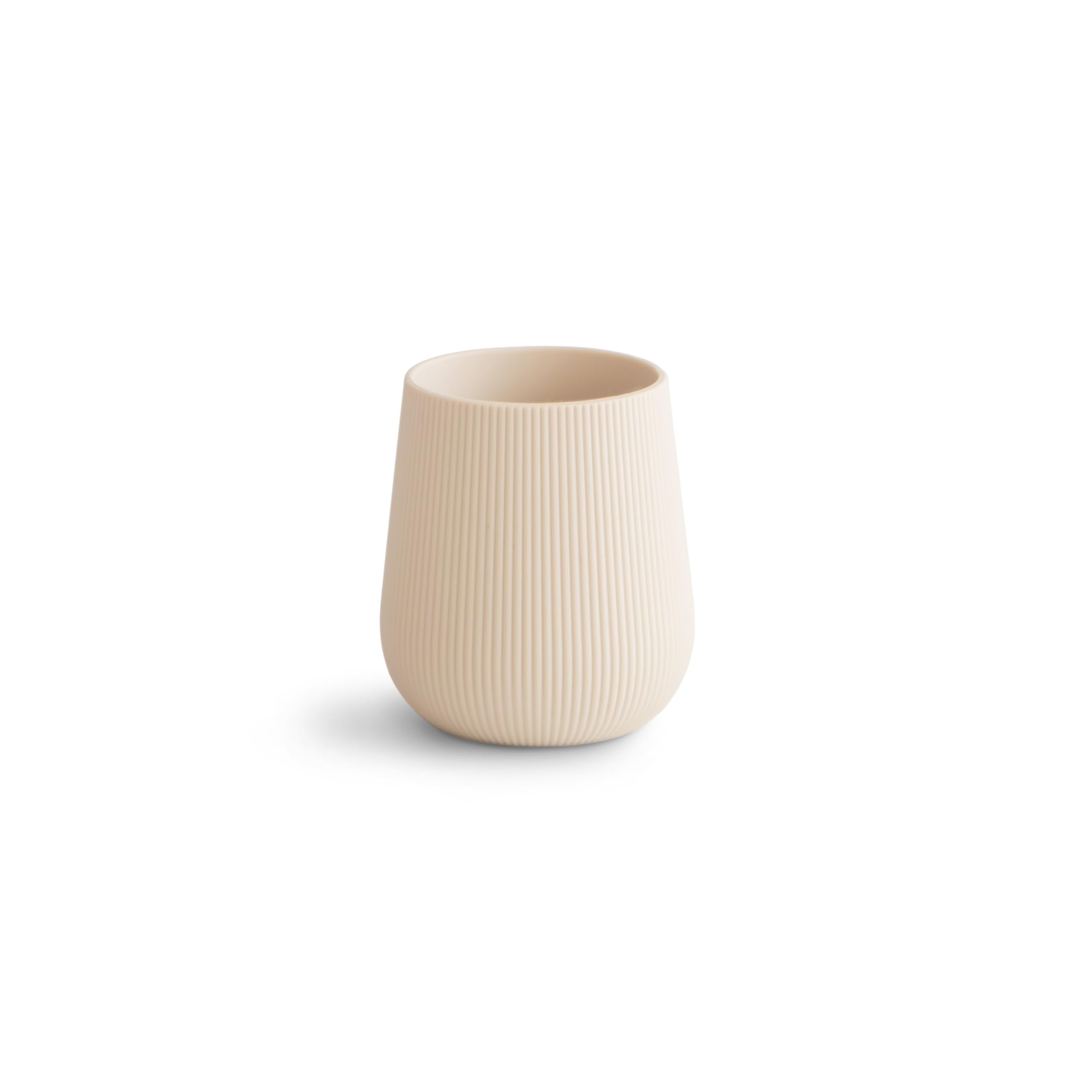 Mushie silicone starter cup with grip texture aids easy open-cup practice.