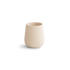 Mushie silicone starter cup with grip texture aids easy open-cup practice.