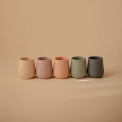 Mushie starter cup with weighted base helps prevent tipping during meals.