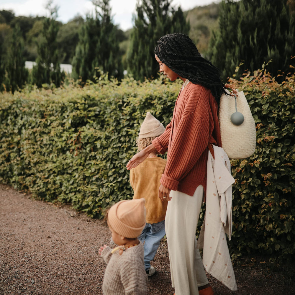 Two-pacifier capacity of Mushie holder emphasizes practical storage during outings
