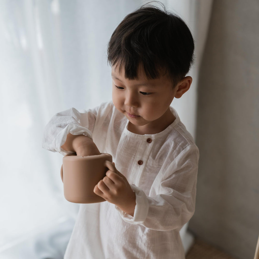 Mushie snack cup on-the-go use during outings and errands.