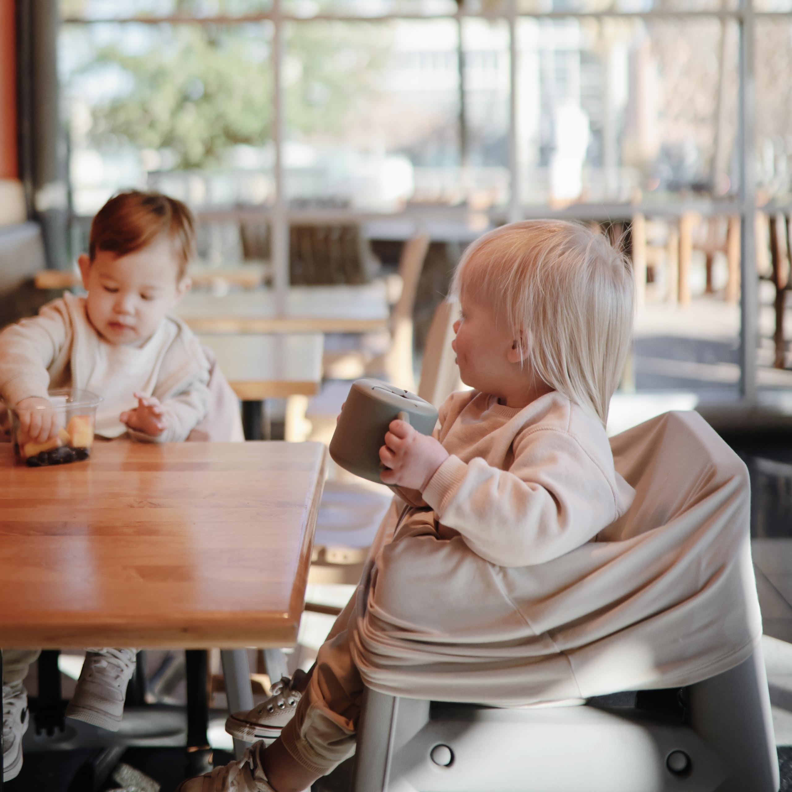 Mushie silicone snack cup, self-feeding design for independent eating.