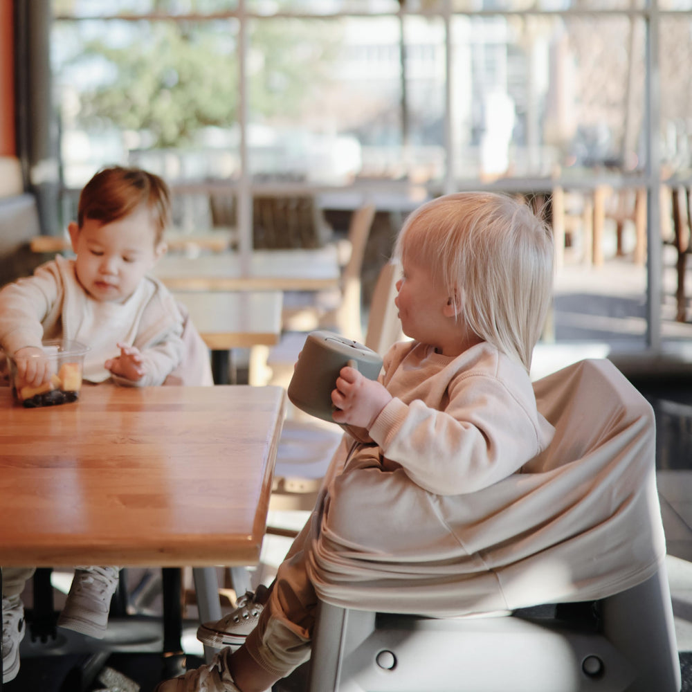 Mushie silicone snack cup, self-feeding design for independent eating.