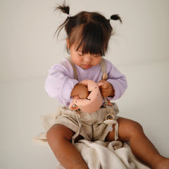 Mushie snack cup with soft opening for easy access by little hands.