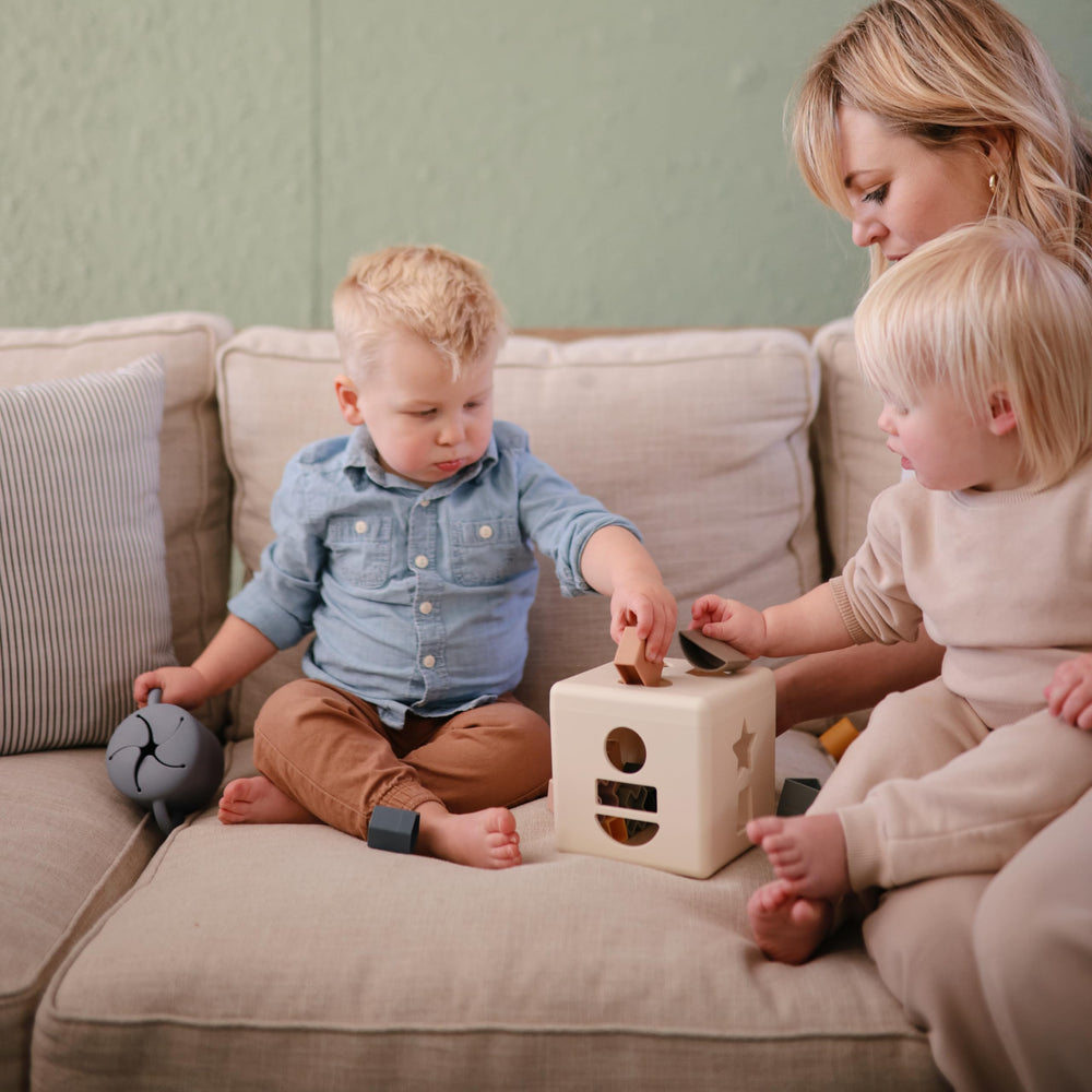 Mushie silicone snack cup soft opening helps little hands pull snacks.
