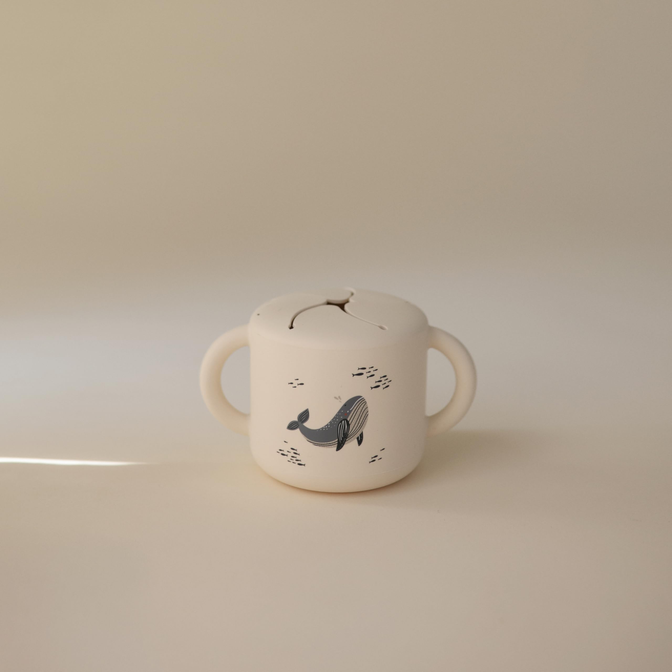 Mushie snack cup spill-proof design keeps snacks secure during travel