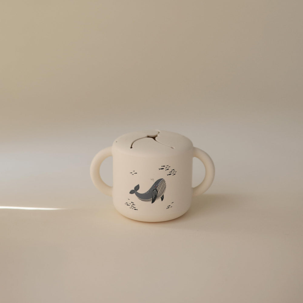 Mushie snack cup spill-proof design keeps snacks secure during travel