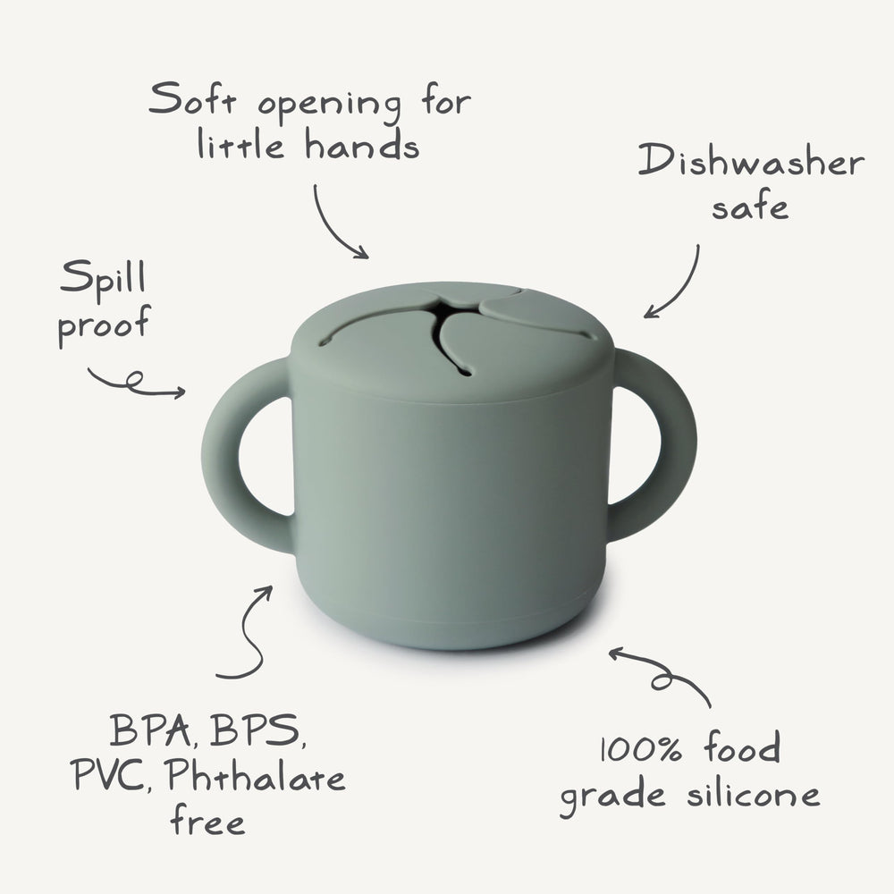 Mushie silicone snack cup with spill-proof design keeps snacks contained during car rides.