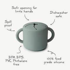 Mushie silicone snack cup with spill-proof design keeps snacks contained during car rides.