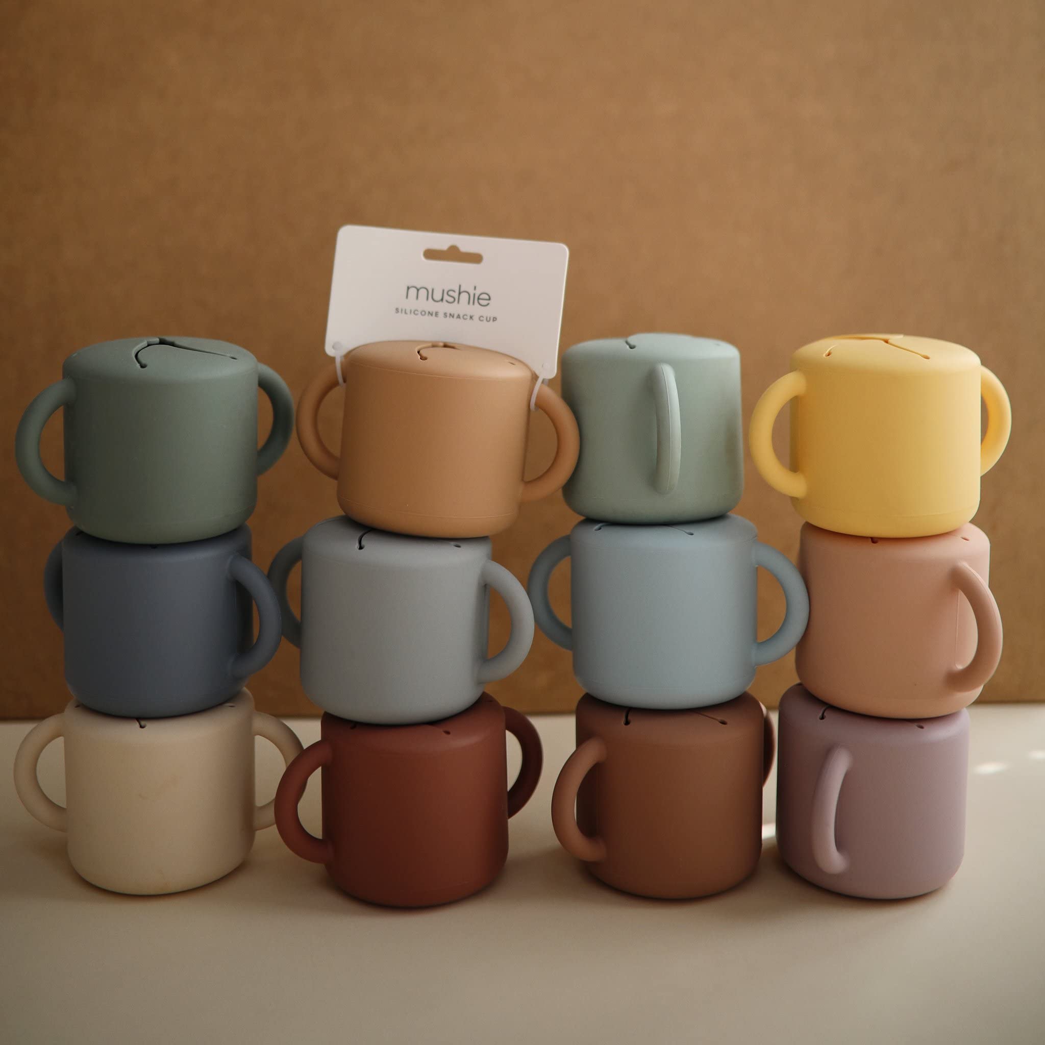 Mushie silicone snack cup supports on-the-go snacking for busy families.