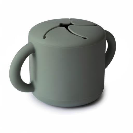 Mushie snack cup in toddler-use setting during everyday moments.