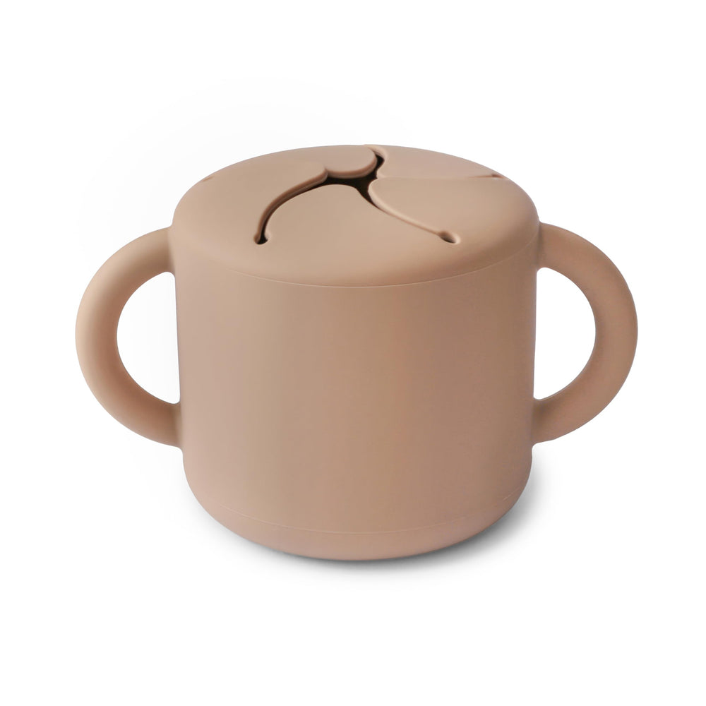 Mushie Silicone Snack Cup with two handles for easy grip and self-feeding.