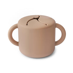 Mushie Silicone Snack Cup with two handles for easy grip and self-feeding.