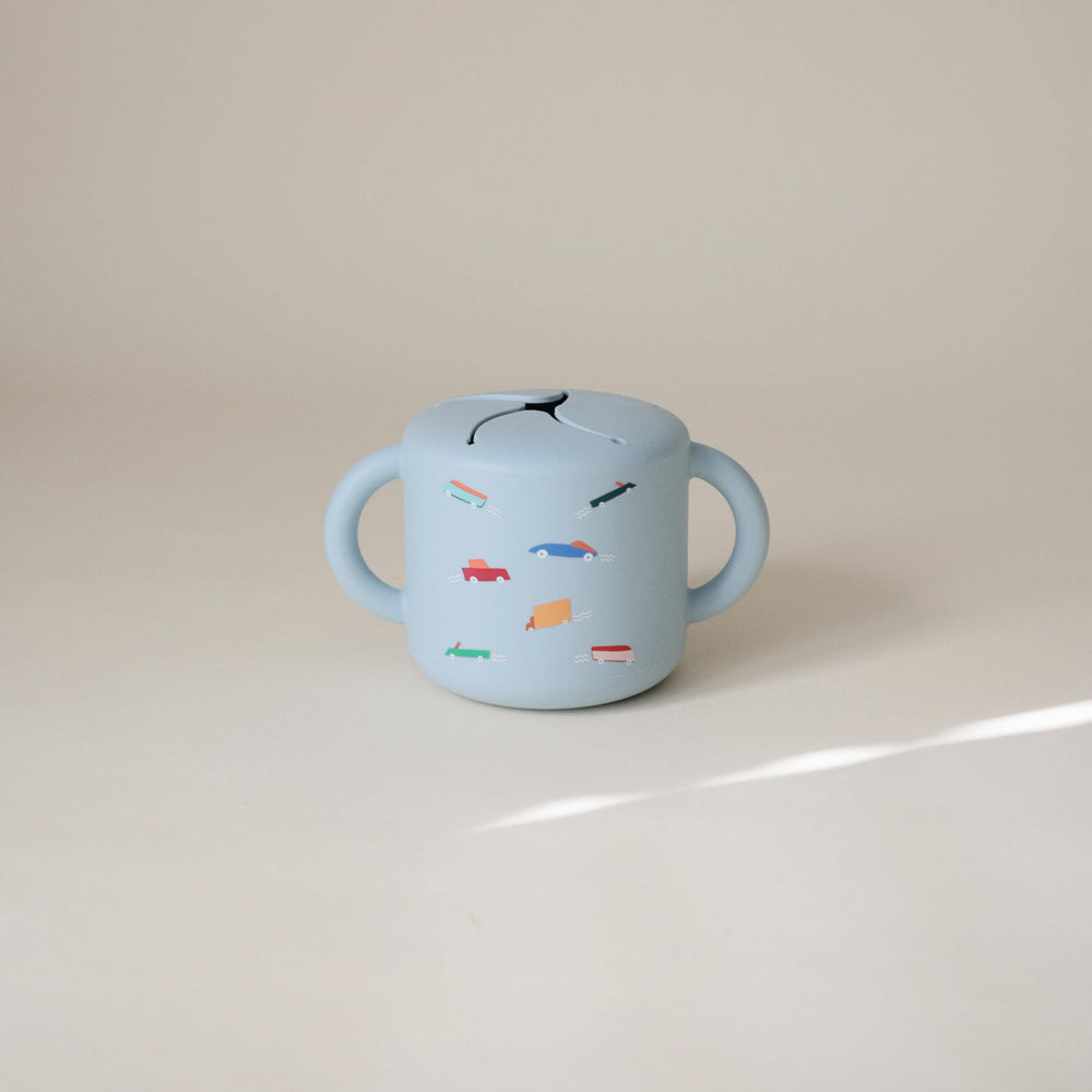 Mushie snack cup with two handles for an easy grip.
