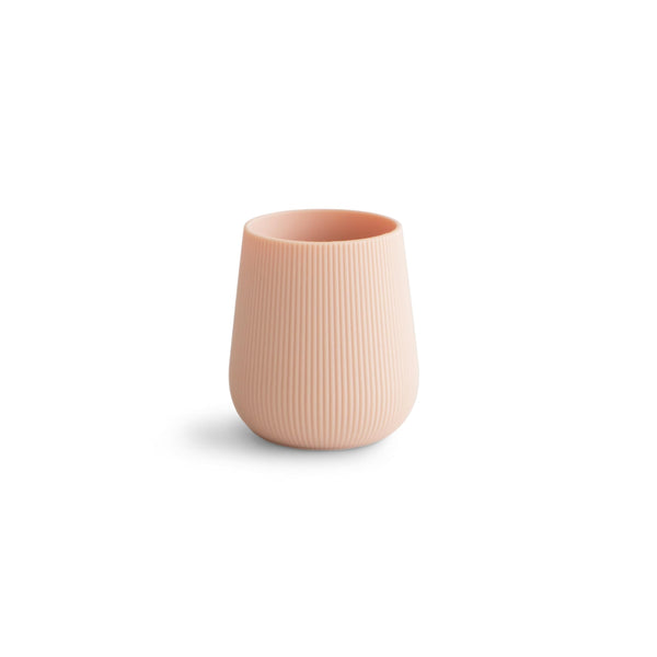 Mushie silicone starter training cup blush top view with non-slip grip for tiny hands.