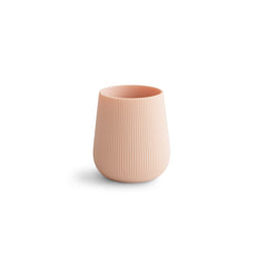 Mushie silicone starter training cup blush top view with non-slip grip for tiny hands.