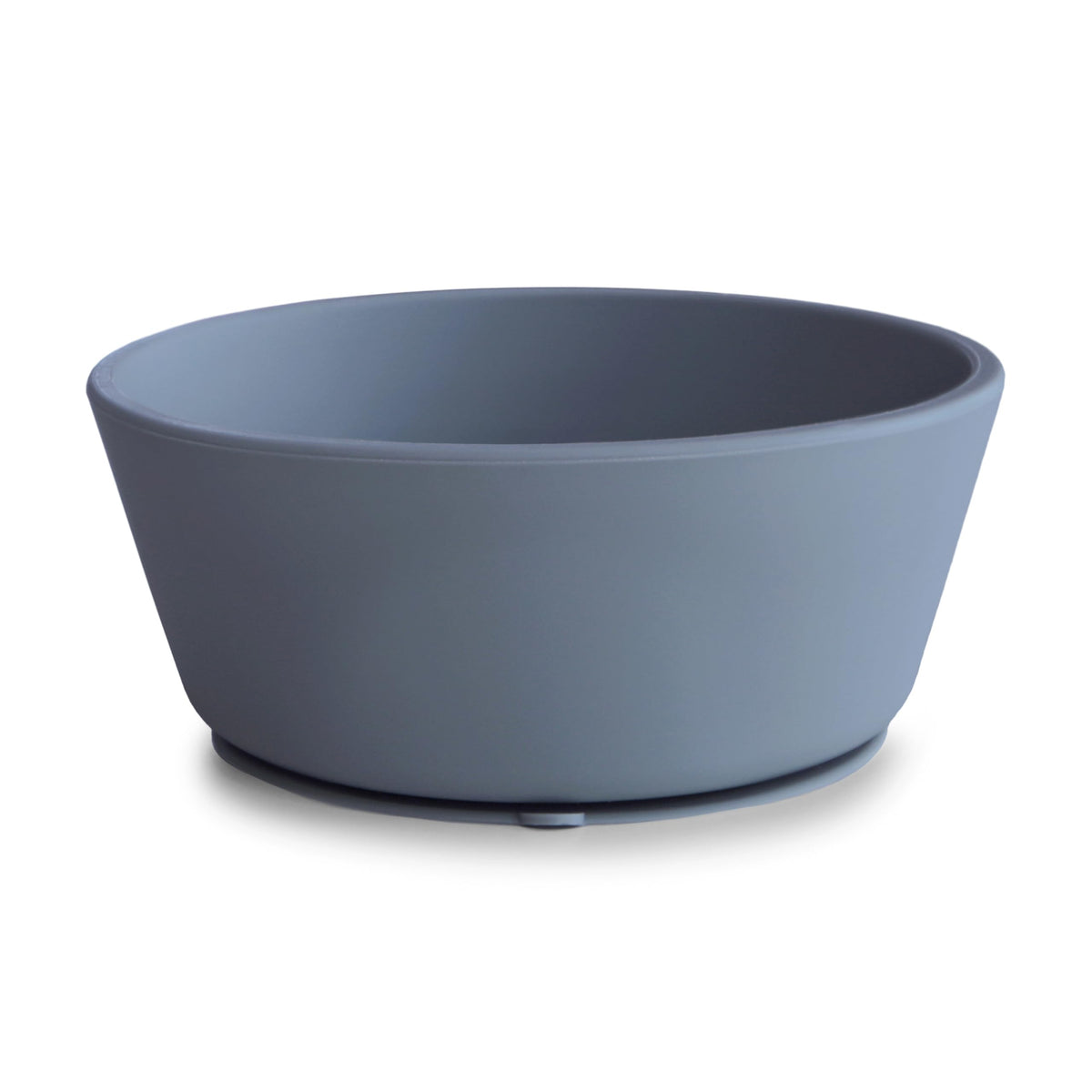 Mushie silicone suction bowl with anti-slip base prevents spills during self-feeding.