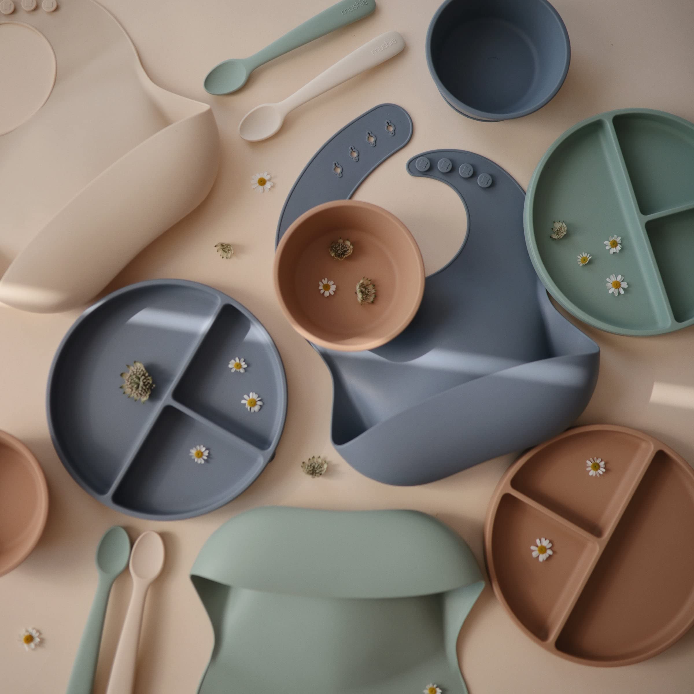 Mushie bowl clings to smooth surfaces, helping little eaters practice self-feeding.