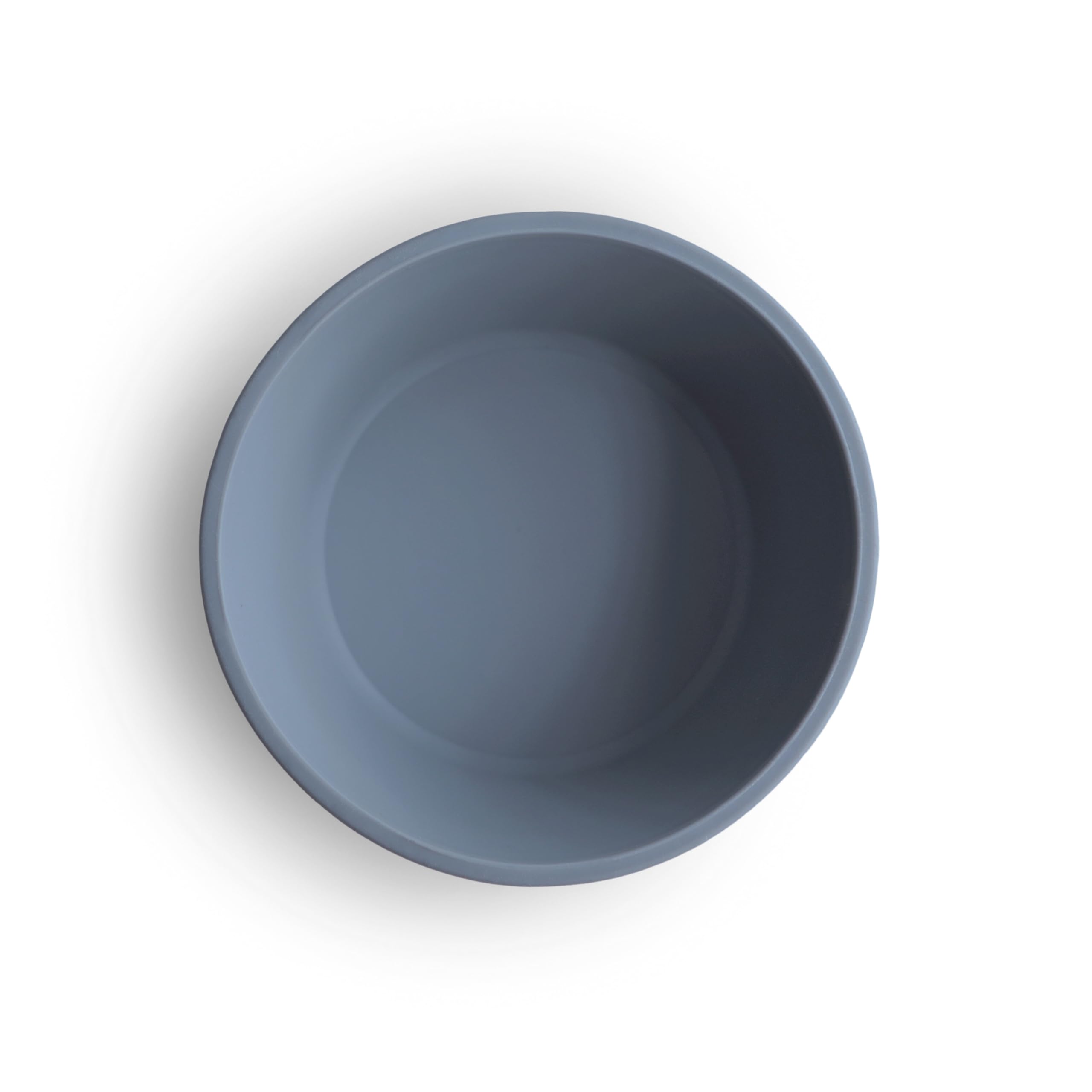 Mushie suction bowl in use for self-feeding, reducing mess at mealtime.
