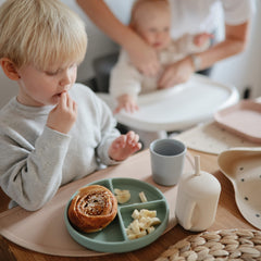 Mushie three-part divided plate to guide toddler portions during meals