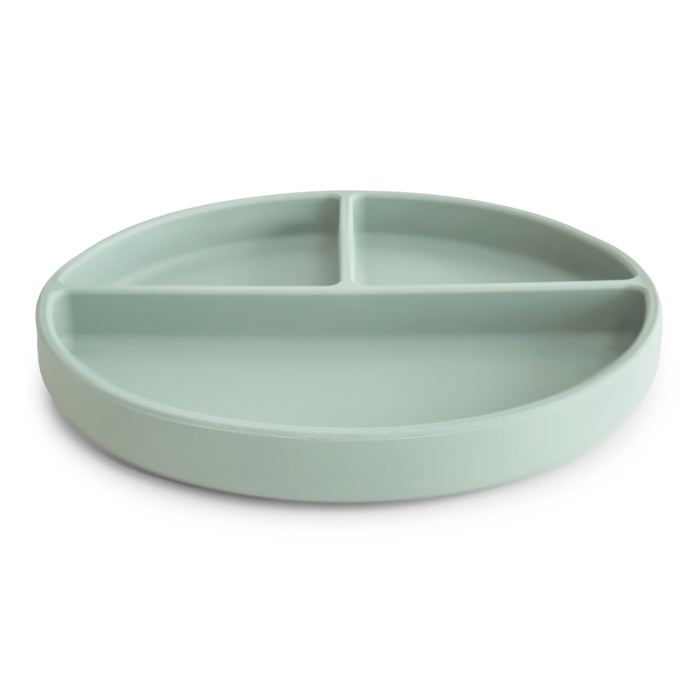 Mushie suction plate on table demonstrates anti-slip design for self-feeding beginners