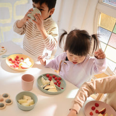 Mushie daffodil plate during baby mealtime with soft silicone feel
